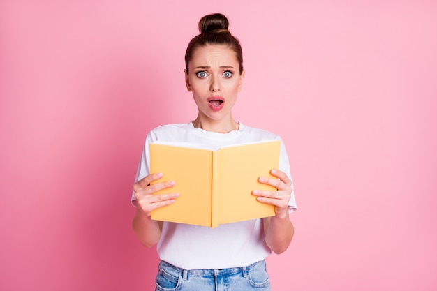 Photo of astonished horrified girl feel fear read book impressed wear stylish white outfit