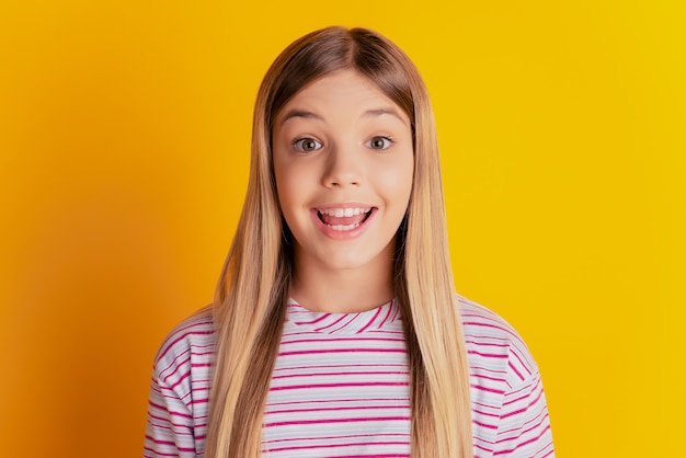 Photo of astonished model child scream over yellow background