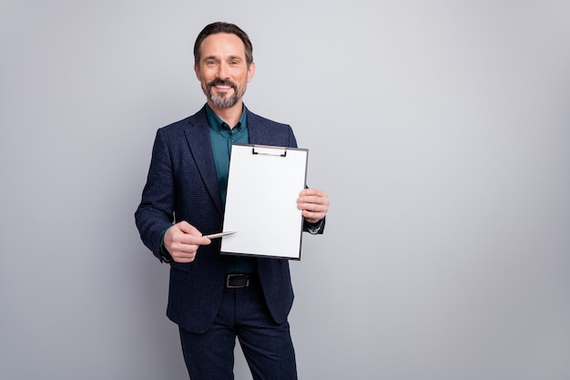 Photo of attractive businessman showing contract clipboard direct pen empty paper space