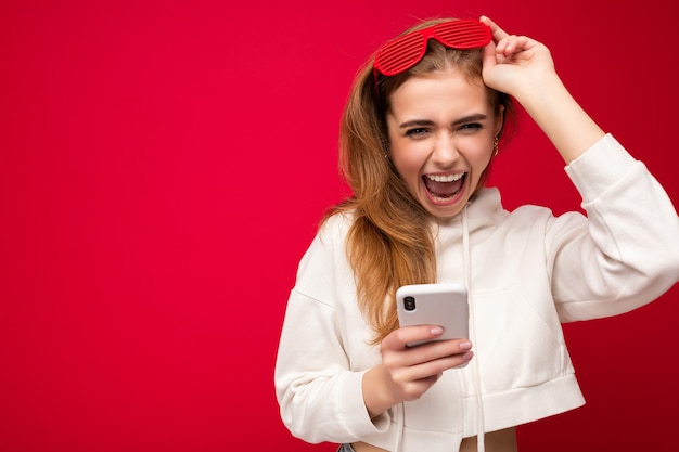 Photo of attractive crazy amazed surprised young woman wearing casual stylish clothes standing isolated