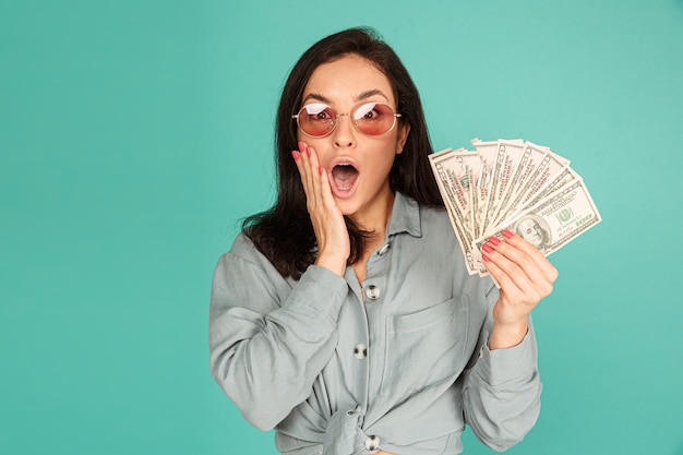 Photo of attractive lady in sunglasses is surprised of money