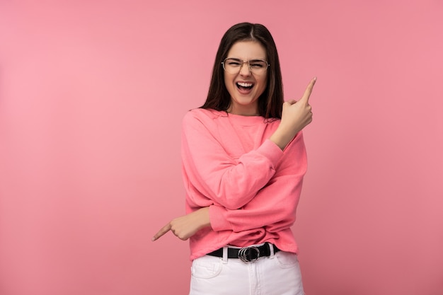 Photo of attractive woman in glasses smile point fingers up and down