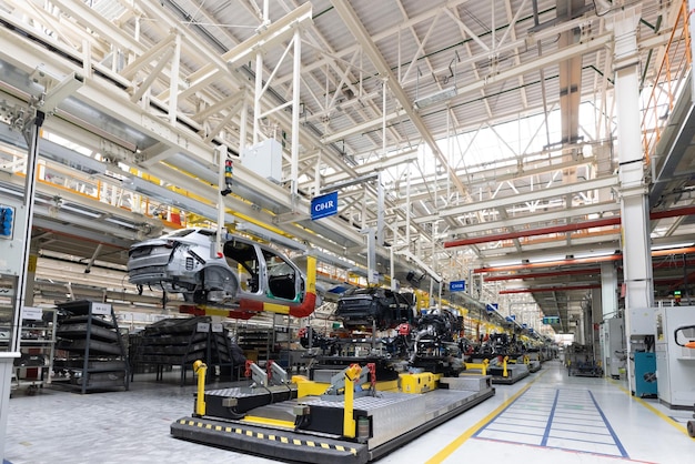 Photo of automobile production line welding car body modern car\
assembly plant auto industry