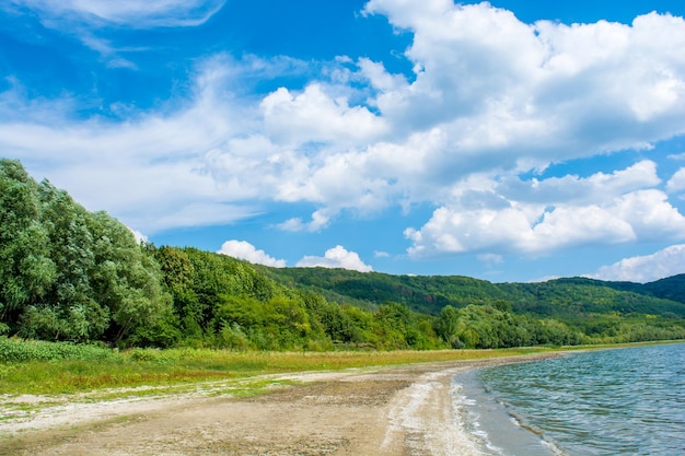 Photo of a beautiful beach near blue bay at summer time