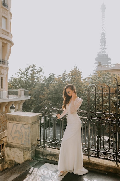 Photo of a beautiful brunette bride in a luxurious wedding dress in France