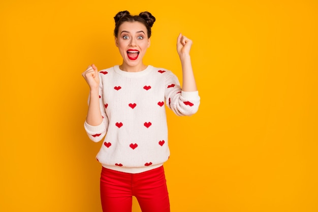 Photo of beautiful crazy lady raise fists celebrating invitation romantic date screaming loudly wear hearts pattern white sweater