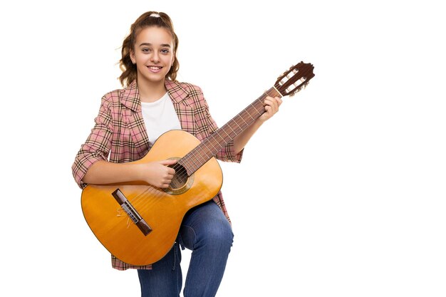 Photo of beautiful cute adorable smiling brunette teenage girl with ponytail in stylish plaid jacket