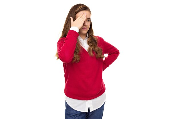 Photo of beautiful cute charming sad brunette teenage girl with long hair in stylish red sweater and