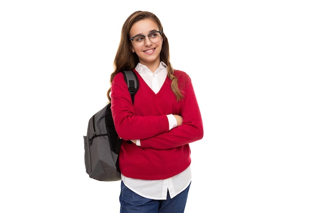 Photo of a beautiful cute charming smiling brunette teenage girl with long hair in a stylish red