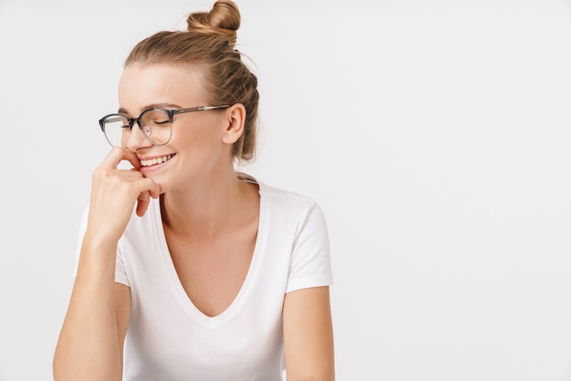 Photo of beautiful happy woman in eyeglasses laughing with eyes closed 