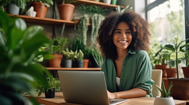 photo of beautiful smiling ethnic woman works remotely on laptop from home