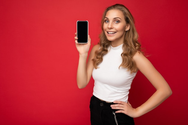 Photo of beautiful smiling young woman good looking wearing casual stylish outfit standing isolated