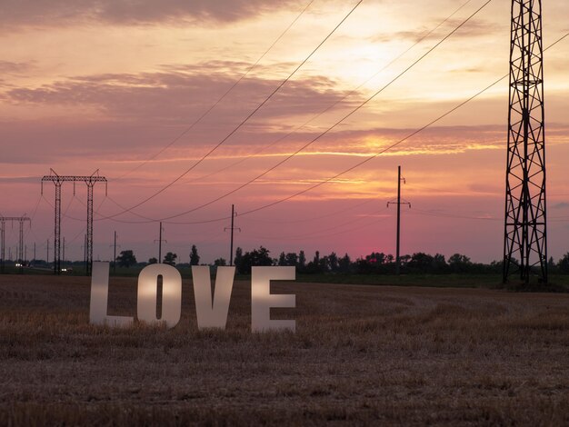 Photo of big white letters with foam on background of sunset in nature