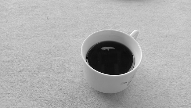 Photo of black coffee cup in a white mug on a white background