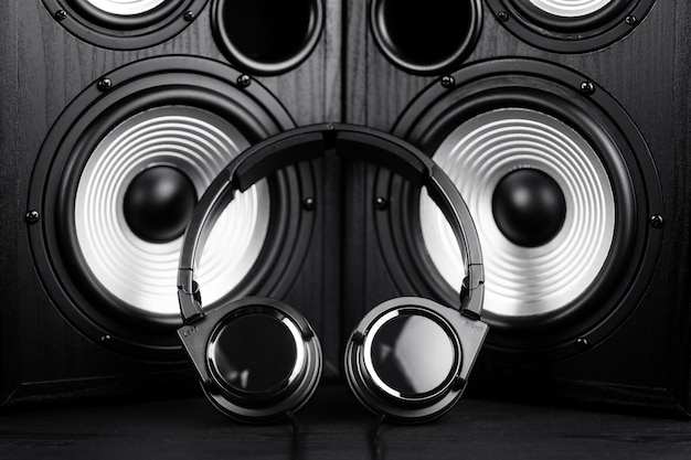 Photo of black music audio speaker and headphones Closeup