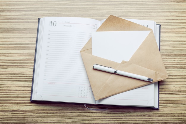 Photo of blank envelope on a  wooden 