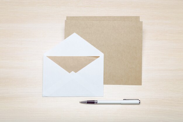 Photo of blank envelope on a  wooden 