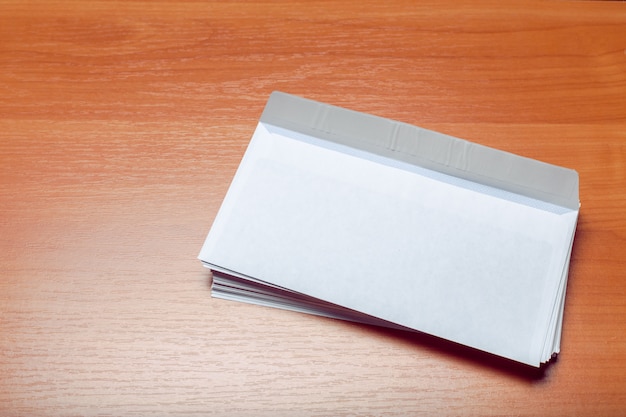 Photo of blank envelope on a  wooden 