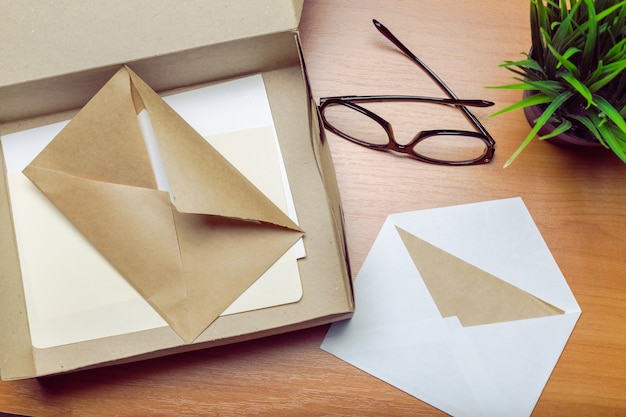 Photo of blank envelope on a  wooden 