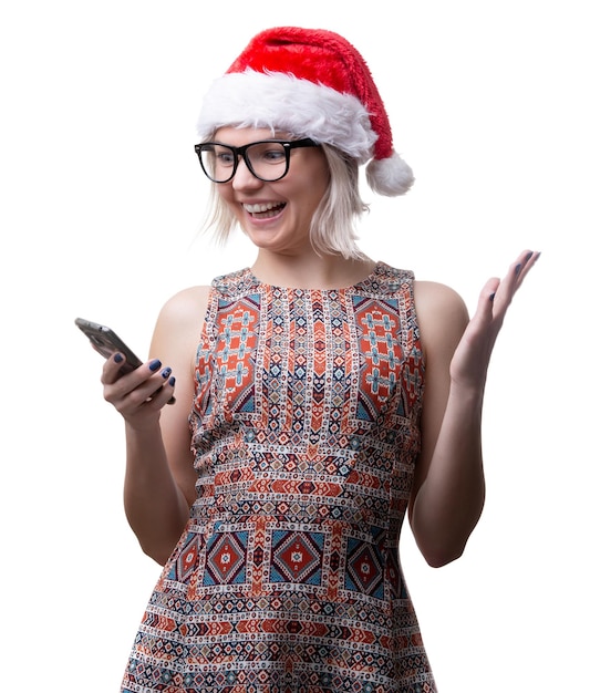 Photo of blonde in glasses and santas cap with phone in hand on empty space