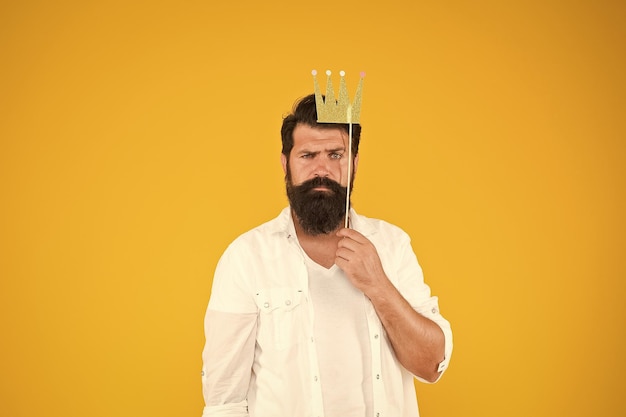 Photo booth fun bearded man king costume party handsome bearded guy king king of party costume party holiday carnival celebration birthday boy guy in yellow background posing with booth props