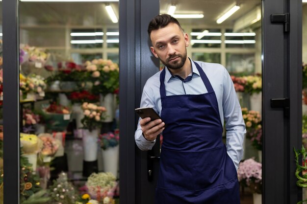 Photo of a bored flower shop owner with no customers