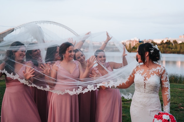 Photo of bridesmaids and gorgeous bride