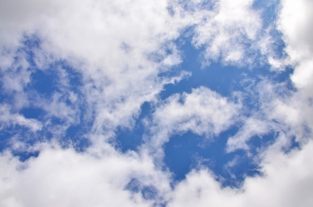 A photo of a bright and shiny blue sky with fluffy and dense white clouds