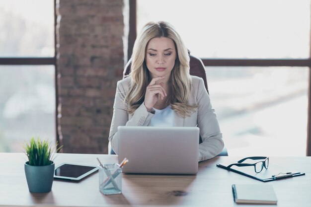 Photo of business lady looking seriously netbook