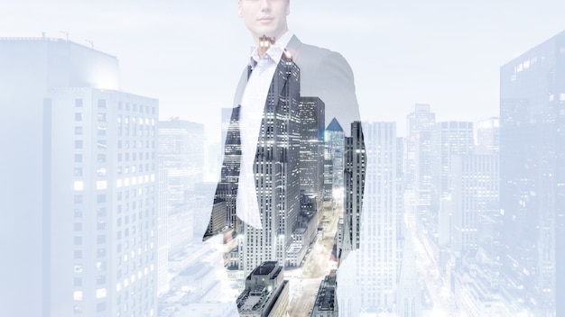 Photo of businessman. Double exposure, city on the wall.