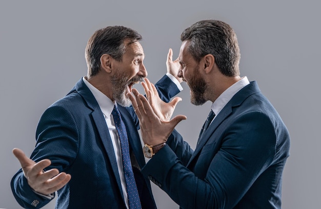 Photo of businessmen arguing with aggression two arguing businessmen isolated on grey