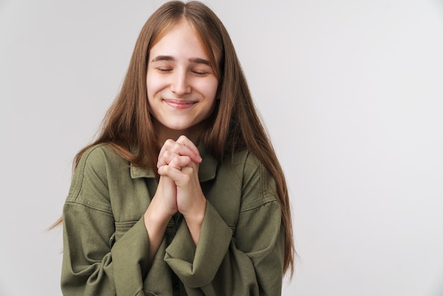 Photo of caucasian happy woman smiling and holding palms together 