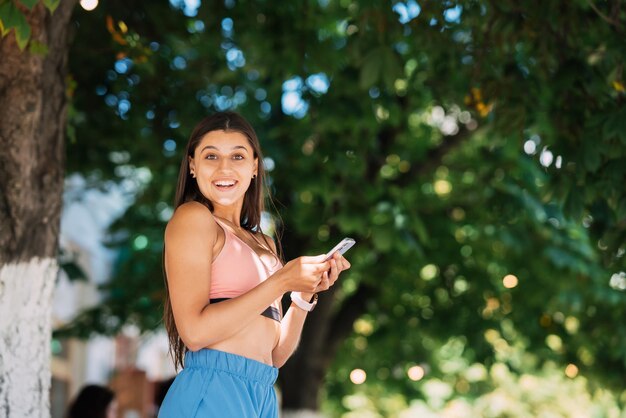 Photo of charming pretty young lady communicating modern gadget