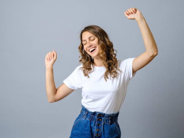 Photo of charming woman dressed white tshirt dancing isolated