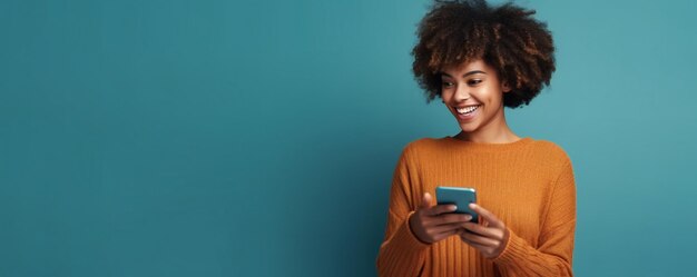 Photo of cheerful delighted African American man typing on the smartphone blue background with copy space