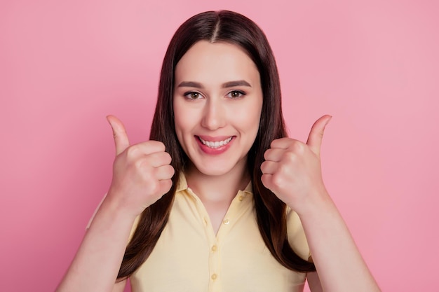 Photo of cheerful lady demonstrate thumb up sign agree feedback on pink background