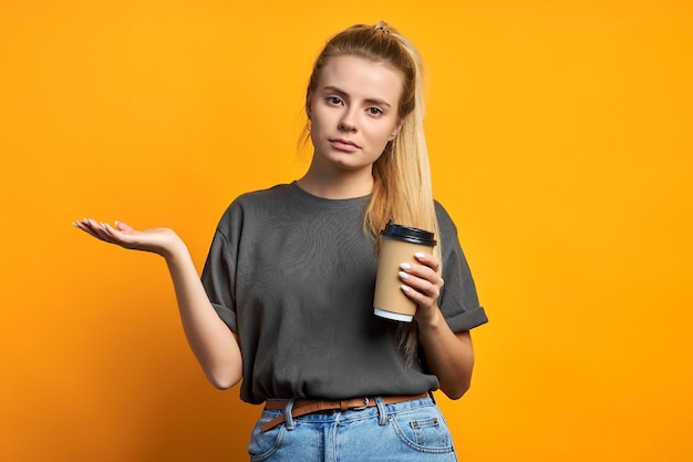 Photo of cheerful positive curly pretty sweet girlfriend holding mug of coffee smiling toothily isolated over vivid color background