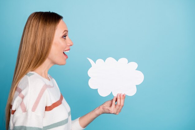 Photo of cheerful positive cute nice woman holding white bubble of speech telling important information isolated pastel color wall