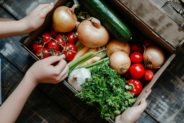 photo close up of box with vegetables in hands