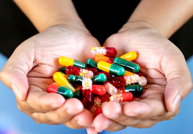 photo closeup shot of hands holding a bunch of colorful capsules