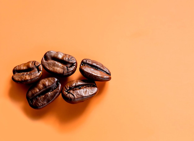 photo coffee beans with copy space on orange surface background