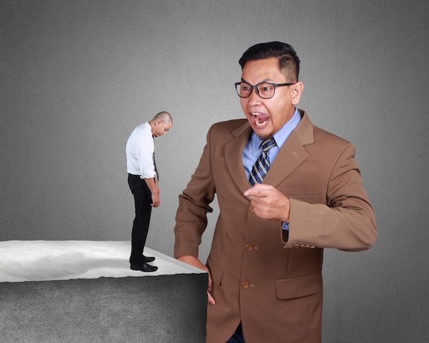 Photo collage Angry Asian businessman manager boss gets really mad and screaming at his worker