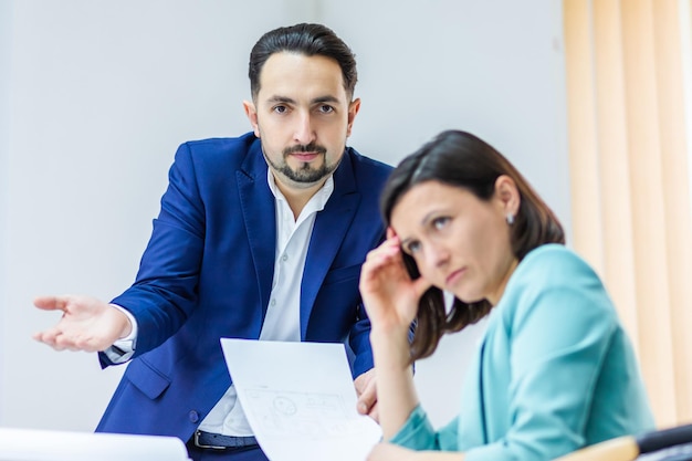 Photo of colleagues in formal clothing discussing business ideas