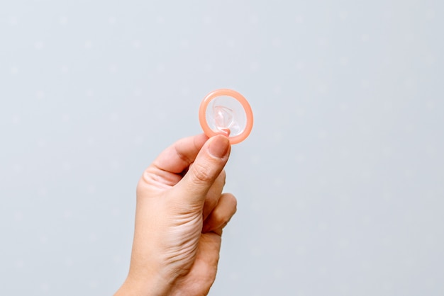 The photo of condom on the girl's hand