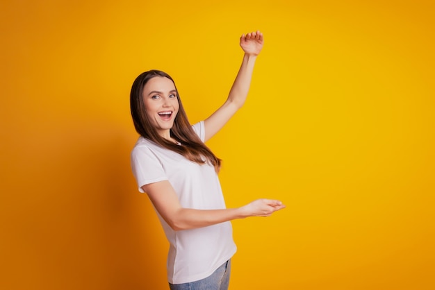 Photo of crazy promoter lady hands measure size empty space wear white t-shirt posing on yellow background