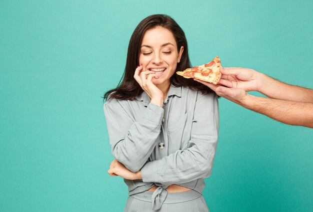 Photo of cute lady is tempted of eating pizza