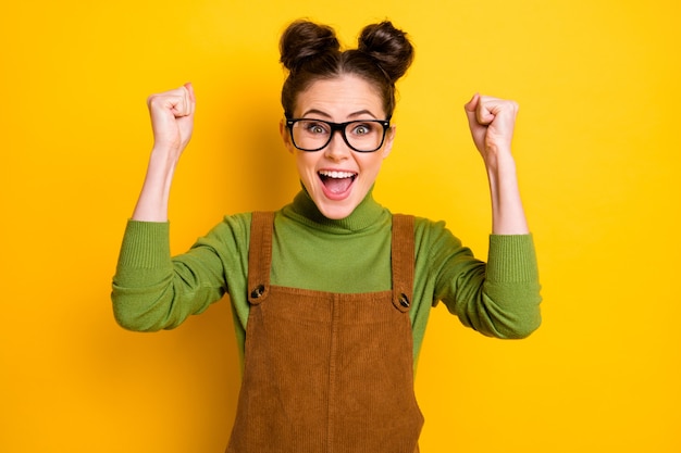 Photo of delighted girl raise fists scream enjoy rejoice good\
grades lesson test