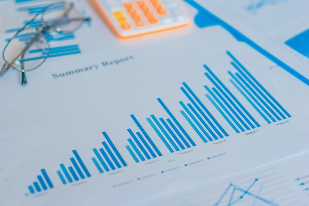 Photo diagrams graphs and numerals in the table on the paper