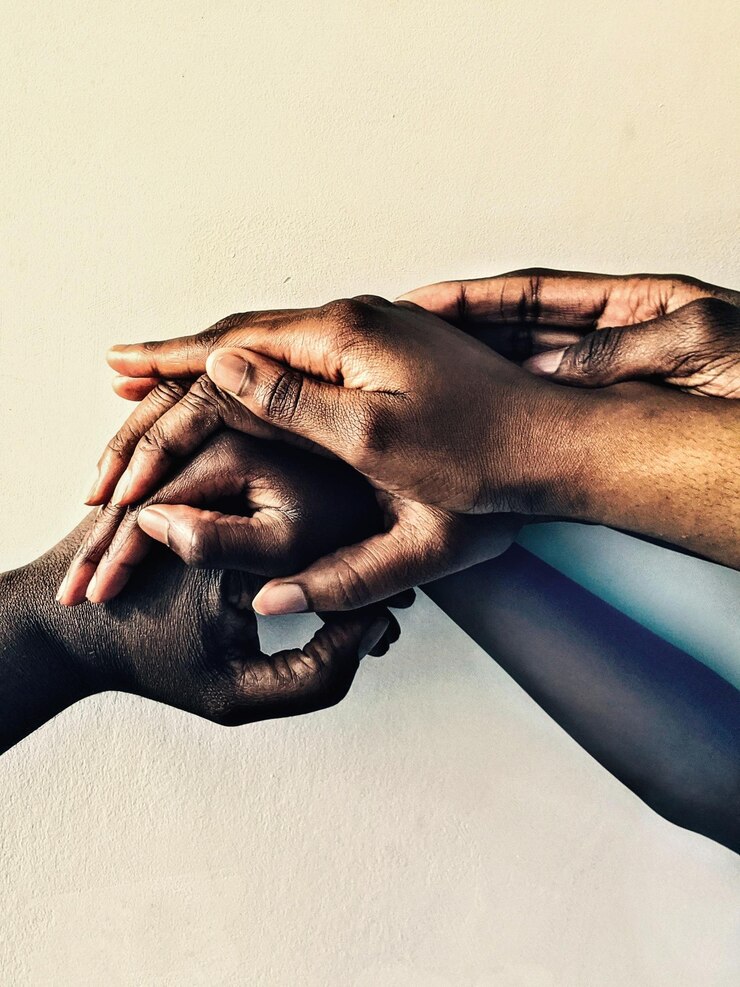 Photo photo of different hands coming together to show togetherness as a team a family or a group