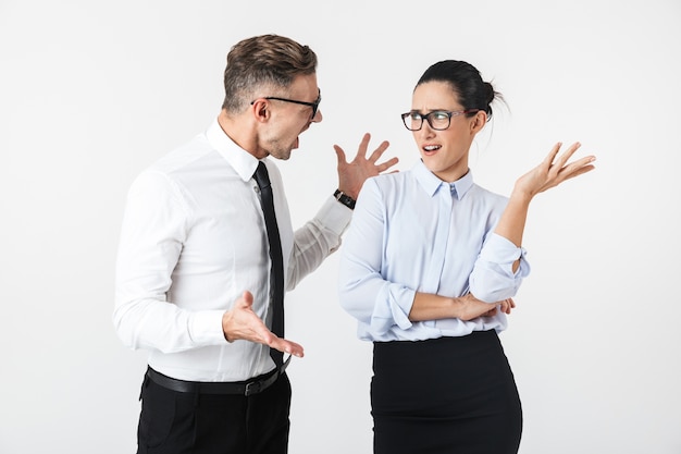 Photo of displeased angry quarrel business colleagues couple isolated over white wall.